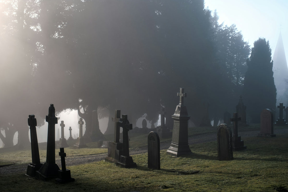 A foggy graveyard with old tombstones